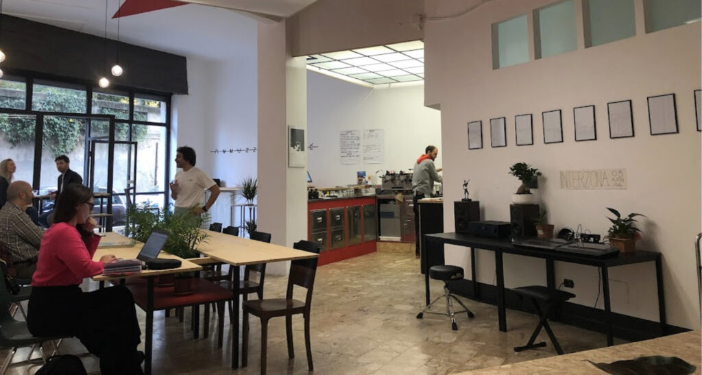 the interior of Ammazza Caffé showing seating, the coffee bar, and some decorations