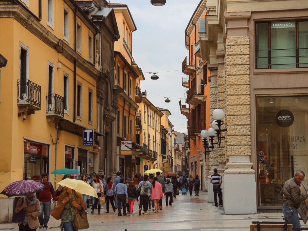 tourists and locals walking through the streets of Verona, Italy