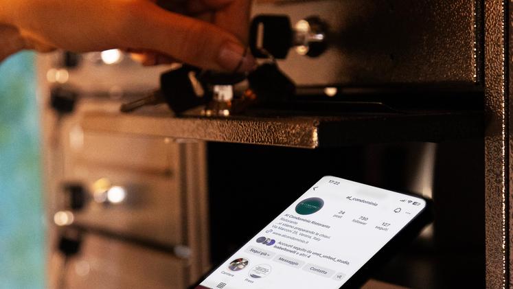 a phone being put into a safety deposit box at the Al Condominio restaurant