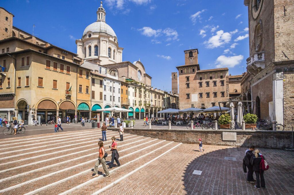 People explore downtown Mantua, Italy during a day trip from Verona