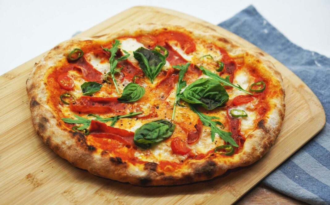 italian pizza sits on a serving board