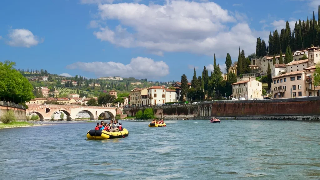 Rafts on a tour in the water of the Adige River in Verona