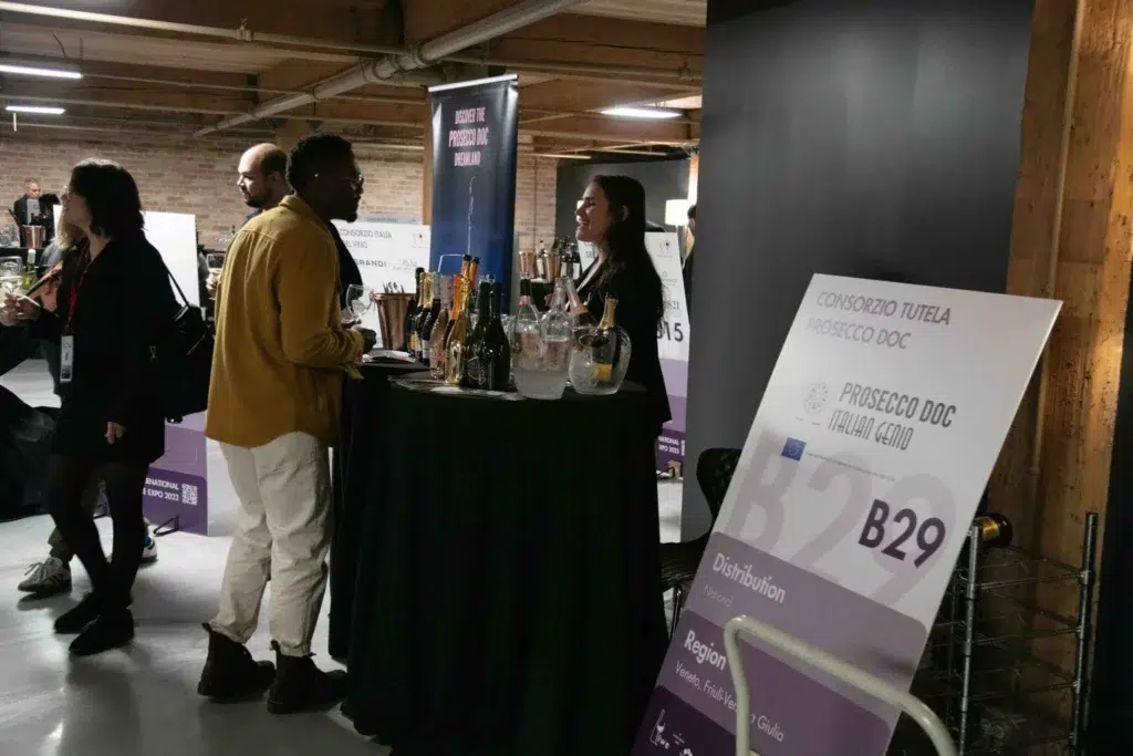 a vendor at Vinitaly offers taste testing of their wines